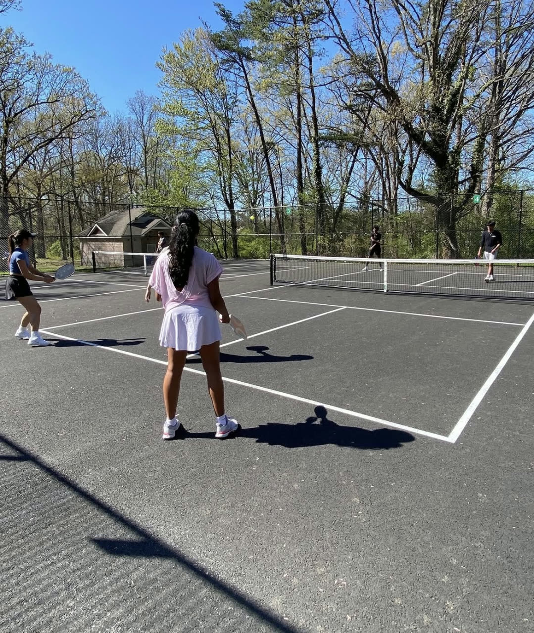 Players on an outdoor tennis court